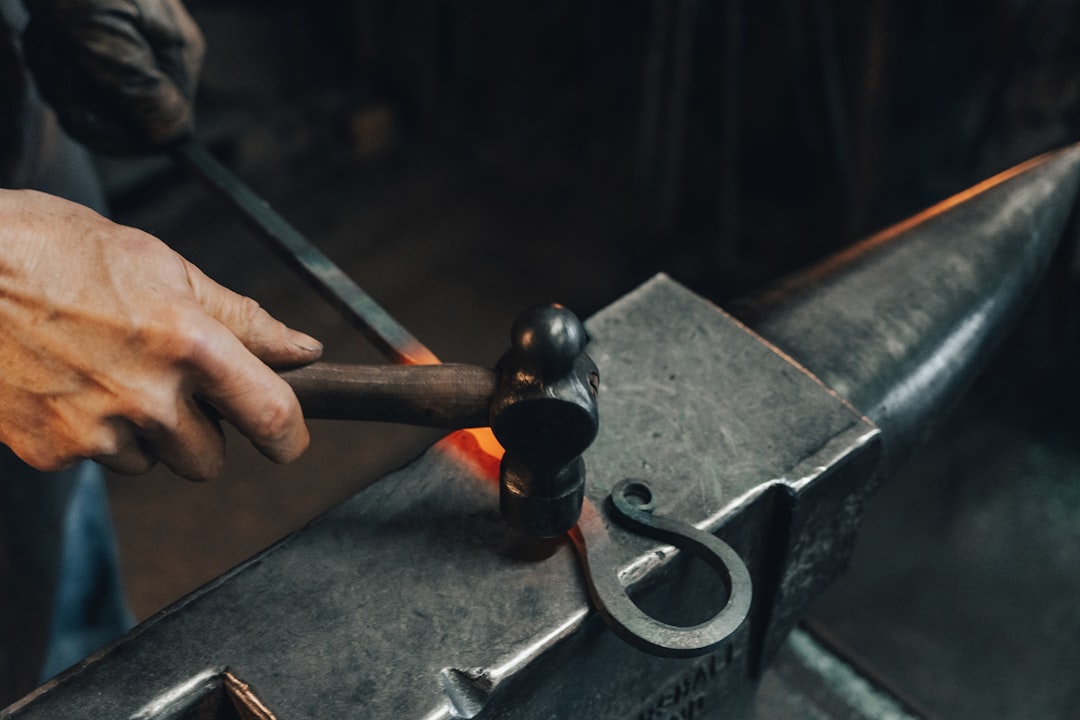 person repairing smartphones under a lighted table